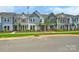 Street view of modern townhouses with manicured lawns at 10121 Mamillion Dr, Huntersville, NC 28078