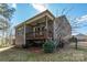 Exterior view of the backyard showcasing a covered deck with a hammock underneath at 1124 Greenbridge Dr, Matthews, NC 28105