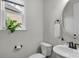 Small half bathroom with modern fixtures and decor and a window with plants at 1124 Greenbridge Dr, Matthews, NC 28105