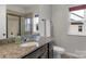 Stylish bathroom featuring granite countertop, modern sink, a framed mirror, and natural light at 1124 Greenbridge Dr, Matthews, NC 28105