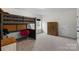 Cozy bedroom featuring a unique bunk bed, wooden dresser, and a comfortable chair at 1124 Greenbridge Dr, Matthews, NC 28105