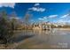 Scenic view of a community pond featuring a charming pavilion and fountain at 1124 Greenbridge Dr, Matthews, NC 28105