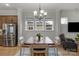 Dining area featuring hardwood floors, a large window with natural light, and an open floor plan at 1124 Greenbridge Dr, Matthews, NC 28105