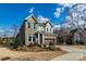 Two-story home with brick and gray siding and a two car garage and landscaping on a sunny day at 1124 Greenbridge Dr, Matthews, NC 28105