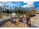 Inviting outdoor fire pit area with chairs, perfect for gatherings near the pond with a fountain and community grilling at 1124 Greenbridge Dr, Matthews, NC 28105