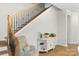 Bright foyer area showcasing wood floors, decorative staircase, and a cozy accent chair with side table at 1124 Greenbridge Dr, Matthews, NC 28105