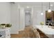 Hallway featuring hardwood floors, white trim, and a view of the kitchen at 1124 Greenbridge Dr, Matthews, NC 28105