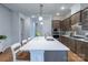 Bright kitchen featuring an island with seating, quartz countertops, and stainless steel appliances at 1124 Greenbridge Dr, Matthews, NC 28105