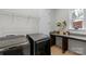 Functional laundry room with modern washer and dryer, countertop space, storage, and natural light at 1124 Greenbridge Dr, Matthews, NC 28105