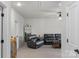 Cozy living room with neutral carpet, leather furniture, and bright lighting at 1124 Greenbridge Dr, Matthews, NC 28105