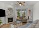 Cozy living room featuring a fireplace, large windows, hardwood floors, and modern decor at 1124 Greenbridge Dr, Matthews, NC 28105