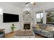 Cozy living room with a fireplace, large TV, hardwood floors and natural light at 1124 Greenbridge Dr, Matthews, NC 28105