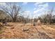 Spacious backyard featuring mature trees and a basketball hoop, perfect for outdoor recreation at 13501 Mullis Rd, Midland, NC 28107