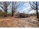 A single-story brick home sits on a spacious lot with mature trees, offering a serene setting at 13501 Mullis Rd, Midland, NC 28107