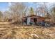 A rustic shed with potential, surrounded by trees and a sprawling backyard, ready for transformation at 13501 Mullis Rd, Midland, NC 28107