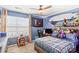 Blue bedroom with surfboard decor, desk, and full-size bed at 138 Byers Commons Dr, Mooresville, NC 28117