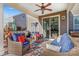 Relaxing covered patio with wicker furniture and ceiling fan at 138 Byers Commons Dr, Mooresville, NC 28117