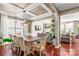 Open dining room with a farmhouse table and views into the living room at 138 Byers Commons Dr, Mooresville, NC 28117