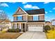 Charming two-story home boasts a well-manicured lawn, attached two car garage, and classic architectural details at 138 Byers Commons Dr, Mooresville, NC 28117