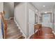 Elegant staircase with a wooden railing and carpeted steps at 138 Byers Commons Dr, Mooresville, NC 28117