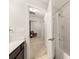 Bright bathroom featuring a shower and an open door leading to a hallway with modern decor and furnishings at 14041 Whistling Teal Dr, Charlotte, NC 28262