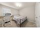 Cozy bedroom featuring a comfortable bed, a functional desk, and ample natural light from the window at 14041 Whistling Teal Dr, Charlotte, NC 28262