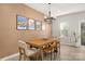 Dining room showcasing a wood table with seating for six, modern chandelier, and artwork on the wall at 14041 Whistling Teal Dr, Charlotte, NC 28262