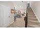Inviting entryway leading to a spacious kitchen, dining area, and staircase, offering a seamless transition at 14041 Whistling Teal Dr, Charlotte, NC 28262