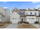 Charming townhome featuring a two-car garage and manicured front yard at 14041 Whistling Teal Dr, Charlotte, NC 28262