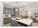 Contemporary kitchen featuring a spacious island, gray cabinetry, and stainless steel refrigerator at 14041 Whistling Teal Dr, Charlotte, NC 28262
