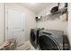 Well-equipped laundry room featuring modern washer and dryer, ample storage shelving, and convenient access at 14041 Whistling Teal Dr, Charlotte, NC 28262