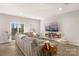 Spacious living room with a large sectional sofa, modern entertainment center, and sliding glass doors to the outdoors at 14041 Whistling Teal Dr, Charlotte, NC 28262