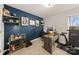 Stylish office with a blue accent wall, modern decor, and a functional workspace for productivity at 14041 Whistling Teal Dr, Charlotte, NC 28262