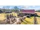 Aerial view of barn, patio, landscaping, and surrounding fields at 15554 Highway 601 S Hwy, Midland, NC 28107