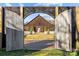 Open wooden gates reveal a picturesque view of the barn at 15554 Highway 601 S Hwy, Midland, NC 28107