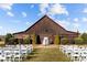 Rustic barn with a red roof and white chairs set up for an outdoor ceremony at 15554 Highway 601 S Hwy, Midland, NC 28107
