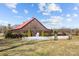 Wooden barn with red roof, and white chairs for an outdoor ceremony at 15554 Highway 601 S Hwy, Midland, NC 28107