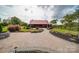 Rustic barn with red metal roof, brick patio, fire pit, and landscaping at 15554 Highway 601 S Hwy, Midland, NC 28107