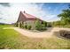 Rustic barn with metal roof, landscaping, and brick walkway at 15554 Highway 601 S Hwy, Midland, NC 28107