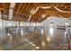 Spacious barn interior with string lights, chandeliers, and tables set for an event at 15554 Highway 601 S Hwy, Midland, NC 28107