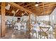 Barn reception area with wooden cross-back chairs and elegant table settings at 15554 Highway 601 S Hwy, Midland, NC 28107