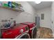 Laundry room with two red Samsung washers and dryers at 15554 Highway 601 S Hwy, Midland, NC 28107