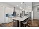 Modern kitchen with white cabinetry, quartz countertops, and a large island at 17925 Stuttgart Rd, Davidson, NC 28036