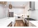 Bright kitchen boasts white cabinets, quartz countertops, and stainless steel appliances at 2002 Summey Ave # 4, Charlotte, NC 28205