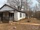White house with porch and yard needs some TLC at 206 Barnyard Ln, Statesville, NC 28625