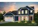 Two-story home with a charming exterior, featuring stone and blue siding at 213 English Arbor Dr # 10, Fort Mill, SC 29715