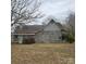 Rear view of house showing grey siding and landscaping at 214 W Ohio W Ave, Bessemer City, NC 28016