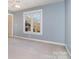 Bright bedroom featuring a large window overlooking the backyard at 2510 Tulip Hill Dr, Charlotte, NC 28270