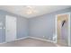 Simple bedroom with light gray walls and ceiling fan at 2510 Tulip Hill Dr, Charlotte, NC 28270