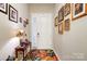 Bright entryway with framed pictures and floral rug at 267 Portrait Way, Indian Trail, NC 28079